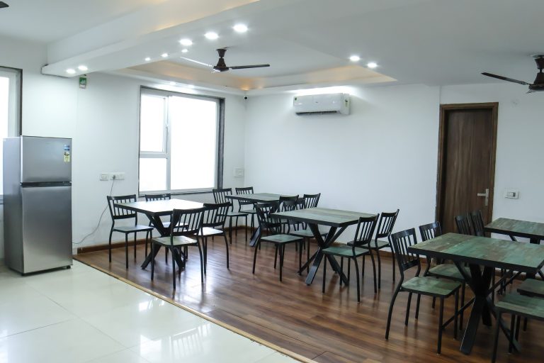 A bright and airy dining space with tables, chairs and air conditioning