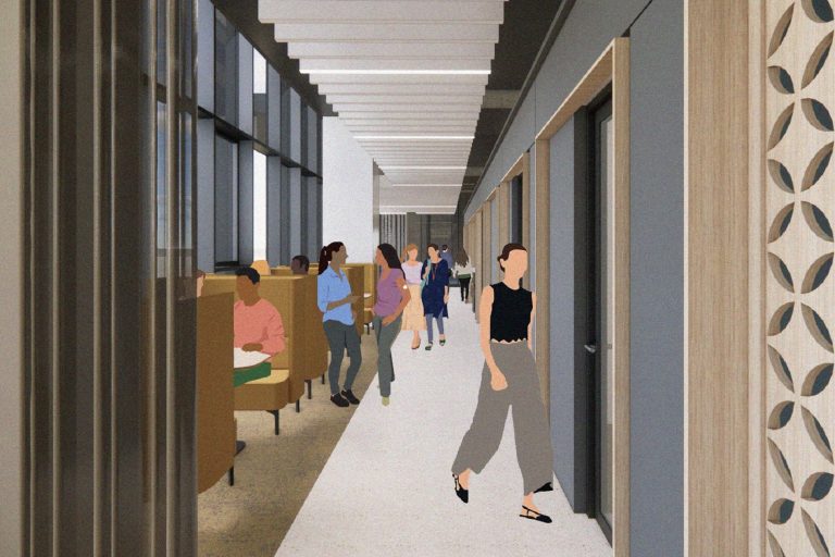 A student hub with working couches to one side and meeting rooms to the other