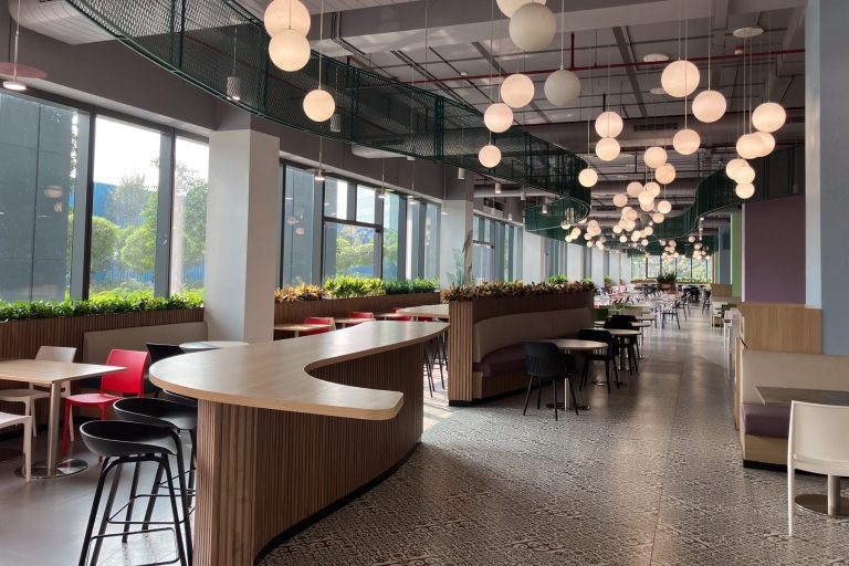 A well furnished canteen and restaurant with a range of seating and stunning pendant lighting