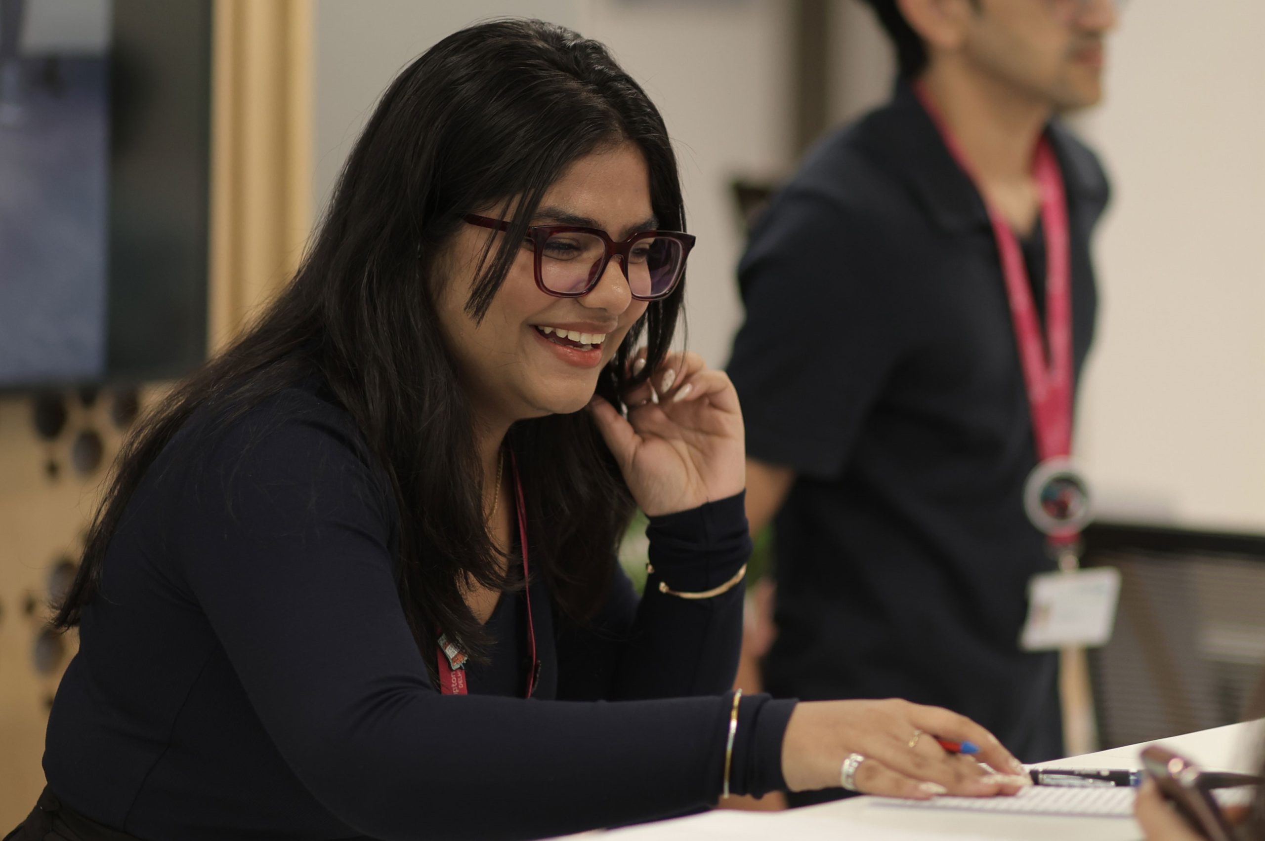 An Accounting and Finance BSc (Hons) degree student smiles as they look to the right and talk to someone