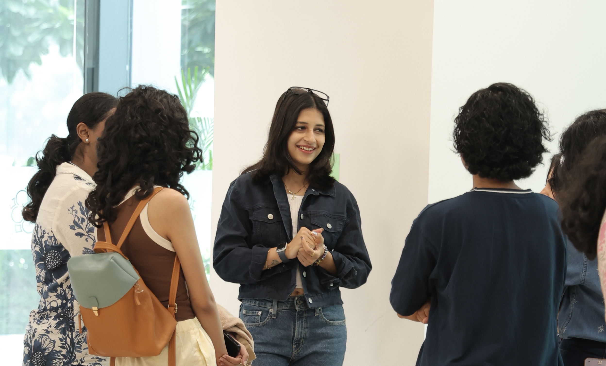 An International Management MSc degree student smiles and talks to a group of fellow students